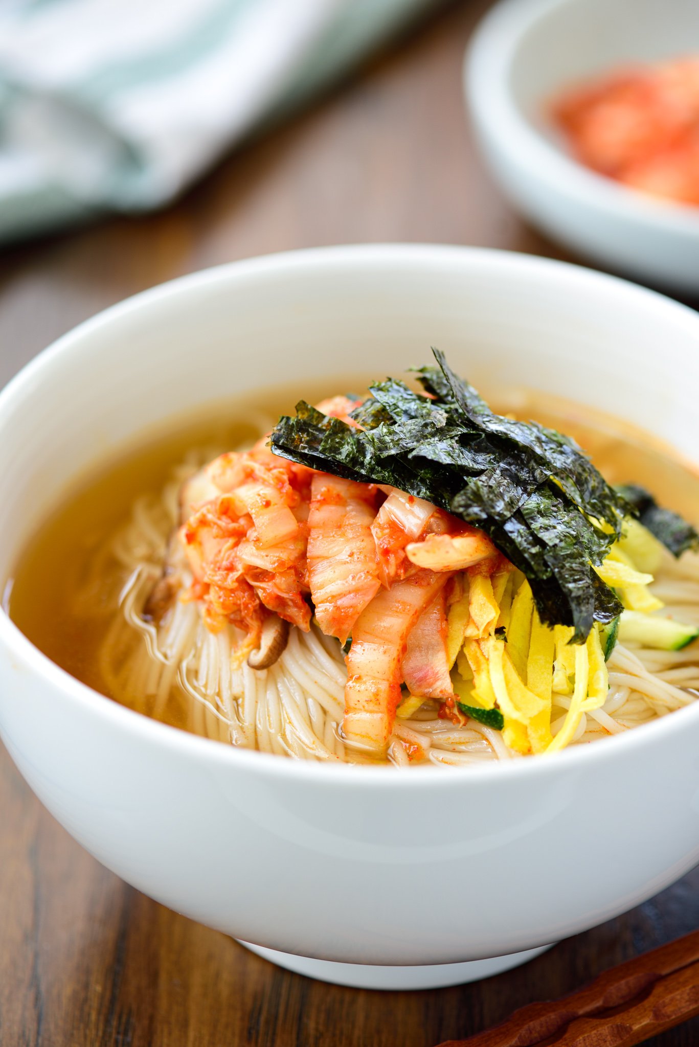 Warm noodle soup with thin wheat noodles and kimchi