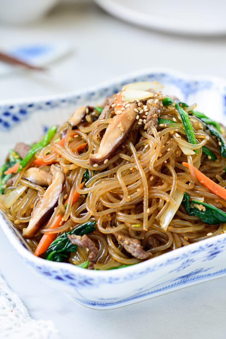 Stir-fried glass noodles with beef and vegetables in a square bowl