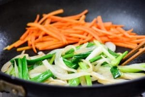 Stir-fry carrot, onion, and scallions for japchae