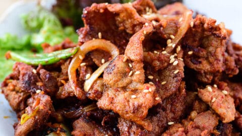 Jeyuk bokkeum (spicy pork BBQ) Spicy pork bulgogi served with lettuce wraps and ssamjang