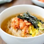 Warm noodle soup with thin wheat noodles and kimchi