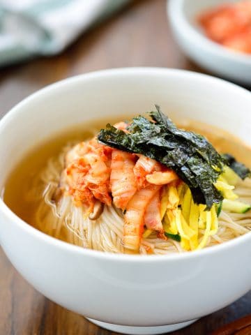 Warm noodle soup with thin wheat noodles and kimchi
