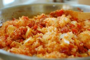 stir frying rice with kimchi and bacon