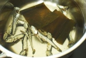 Anchovies and dried kelp in a pot of water