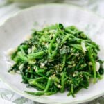 Blanched and seasoned watercress side dish served in a small plate