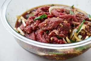 beef bulgogi marinated in a glass bowl