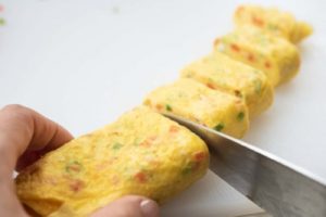 slicing the rolled eggs