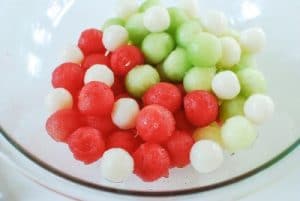 Watermelon and honeydew balls for punch in a glass bowl