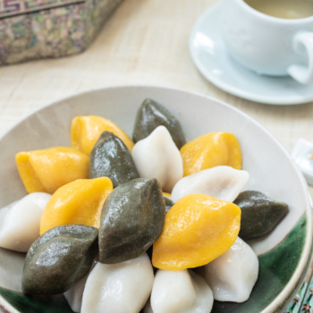 Korean half-moon shape rice cakes in yellow, green and white colors
