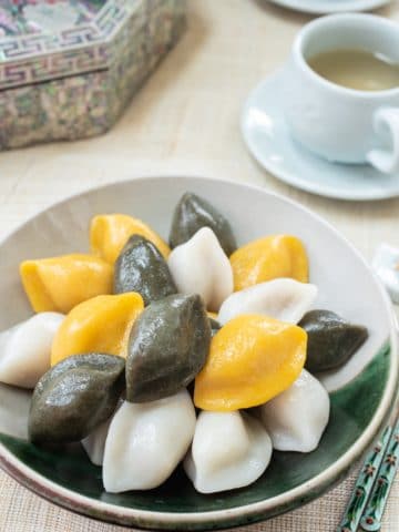 Korean half-moon shape rice cakes in yellow, green and white colors