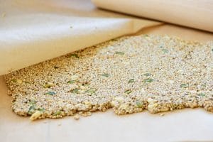 Flattening sesame crunch with a rolling pin