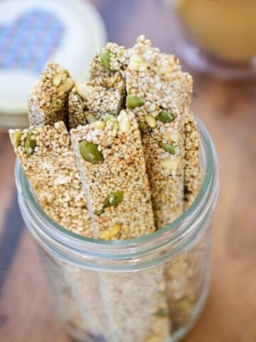 Long sticks of sesame crunch in a small mason jar
