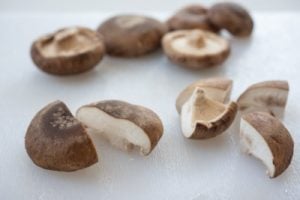Cutting shiitake mushrooms into quarters
