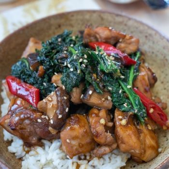 Chicken stir fry with vegetables served in a brown bowl
