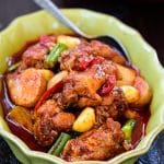 Red spicy braised Korean chicken called dakdoritang in a green casserole