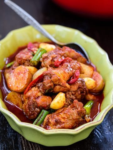 Red spicy braised Korean chicken called dakdoritang in a green casserole