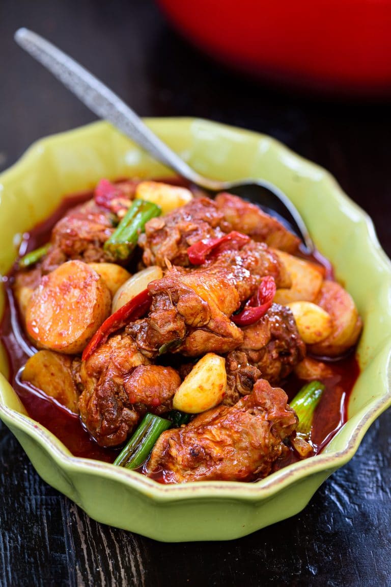 Red spicy braised Korean chicken called dakdoritang in a green casserole