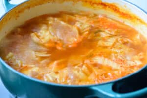 boiling kimchi kongnamul soup in a pot