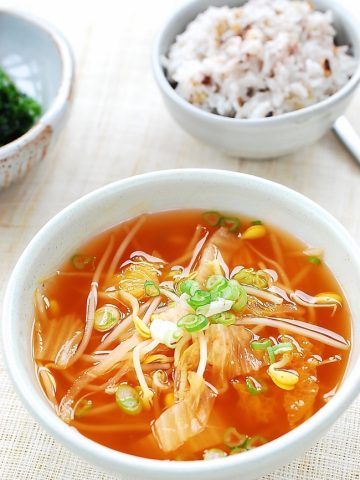 kimchi soybean sprout soup served with a bowl of rice