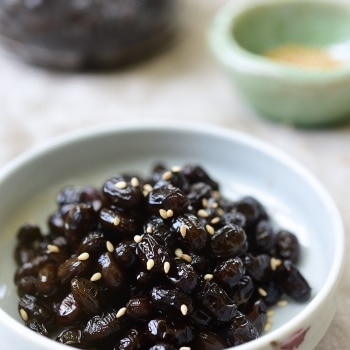 Soy braised soybean side dish garnished with optional sesame seeds