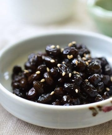 Soy braised soybean side dish garnished with optional sesame seeds
