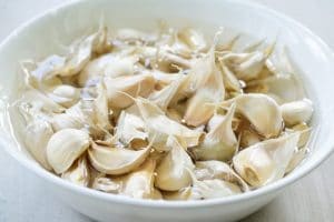 Soaking garlic cloves in water for easier peeling