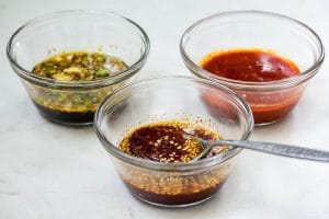 3 different bibimbap sauces in 3 small bowls