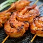 Spicy red shrimp skewers in a grill pan