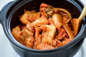 Stir-frying kimchi and pork in a pot