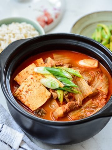 Red spicy kimchi stew in an earthen pot