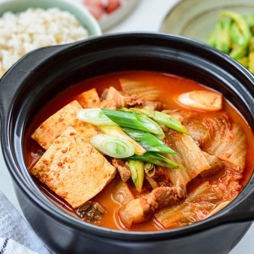 Red spicy kimchi stew in an earthen pot