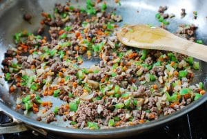 Stir-frying chopped beef and vegetables for fried rice