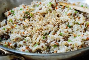 Making fried rice with chopped beef and vegetables in a pan