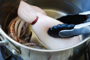 a whole squid boiled in a pot