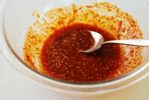 Red Spicy Korean squid salad sauce in a glass bowl