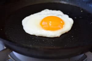 a sunny side egg being fried in a pan
