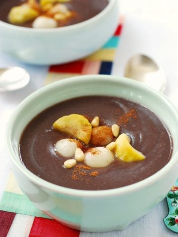 Korean Sweet red bean porridge topped with chestnuts, pine nuts, and rice balls