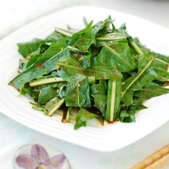Korean-style dandelion salad served in a white plate