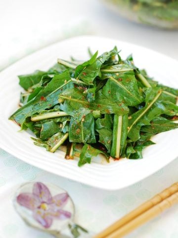 Korean-style dandelion salad served in a white plate