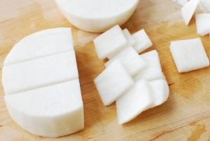 cutting up a block of radish to make kimchi recipe