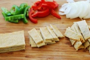 cutting fish cake sheets and vegetables on a cutting board