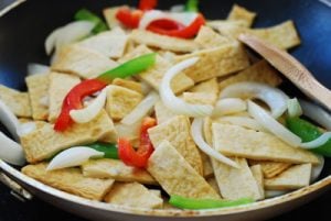 stir frying Korean fish cake and vegetables in a pan