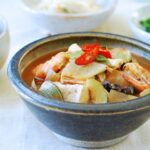Seafood doenjang jjigae served with rice and side dishes