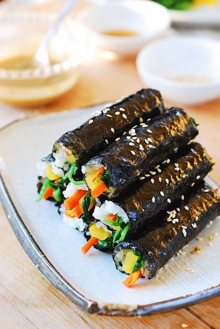 a pile of mini Korean seaweed rice rolls on a plate
