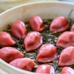 Steaming red half-moon shape rice cake