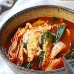 Korean spicy chicken soup with scallions and drizzled egg