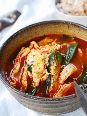 Korean spicy chicken soup with scallions and drizzled egg