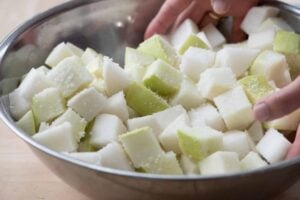 radish cubes being salted in a bowl
