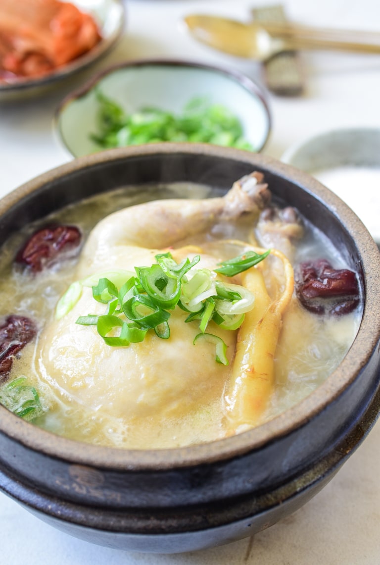 a small whole chicken soup in an earthenware with ginseng