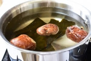 Dashima and shiitake mushrooms in a large pot of water